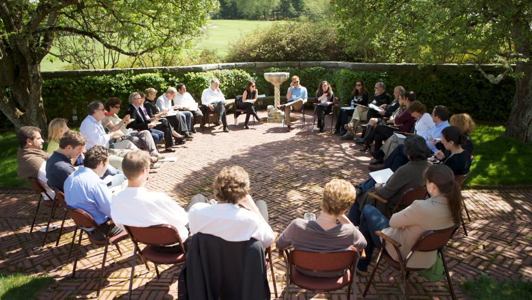 circle of adults sitting in garden