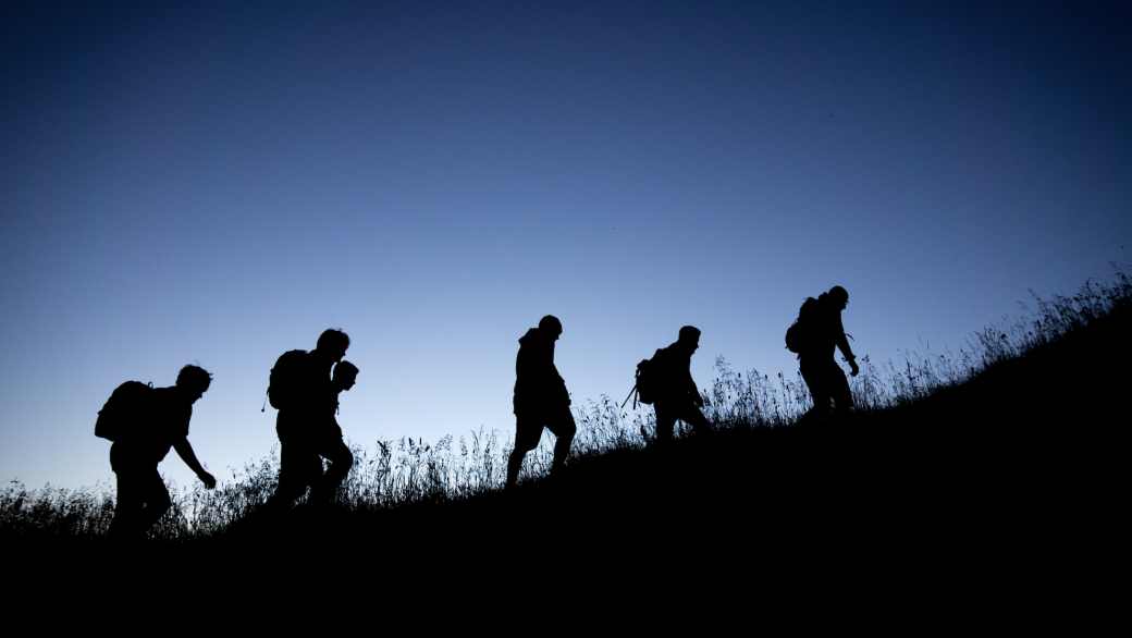 people hiking near dusk