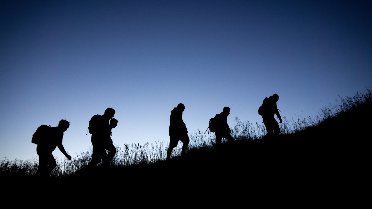 people hiking near dusk