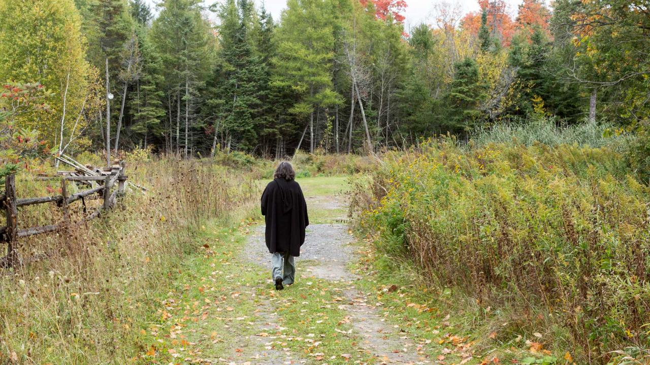Woman walking in field in Canada