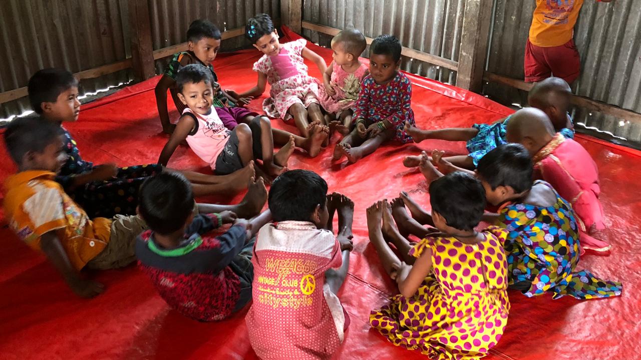 Children sitting in circle in child care center in Bangladesh