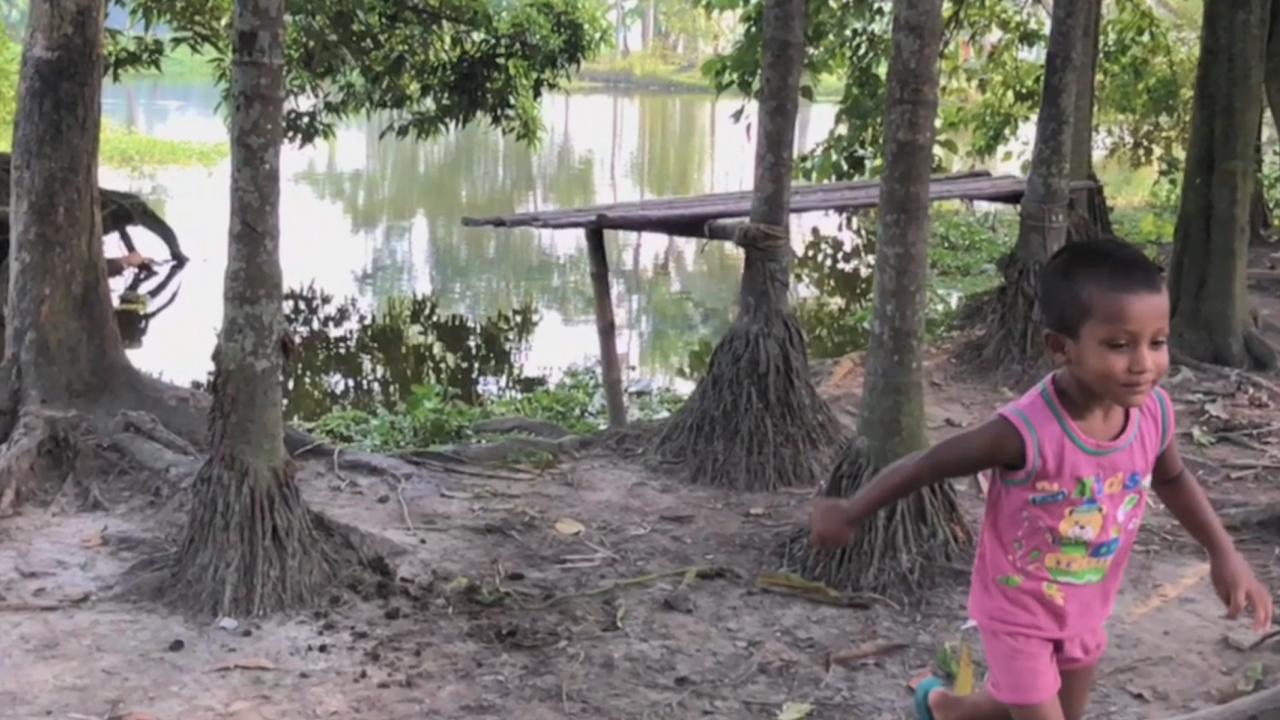 boy running near body of water in Bangladesh