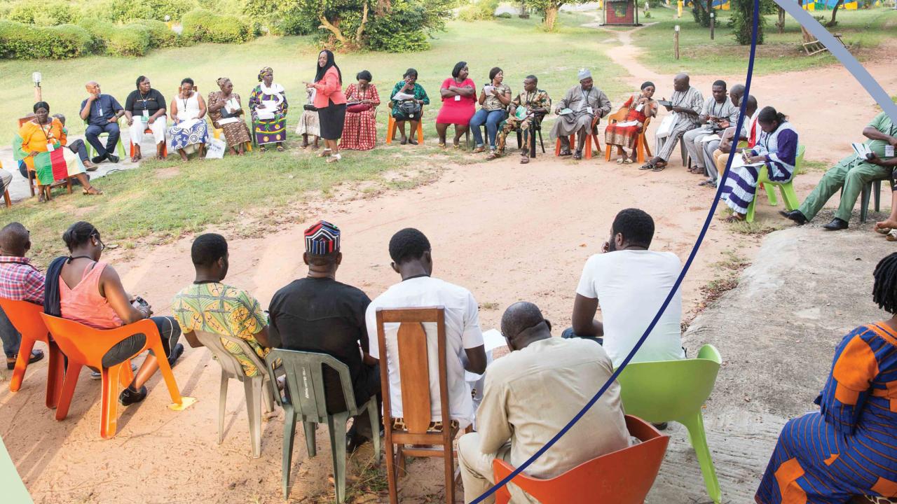 Participants workshop in Nigeria sitting in large circle outside