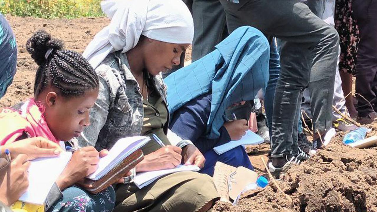 Women farmers in Ethiopia taking notes in on new irrigation methods 