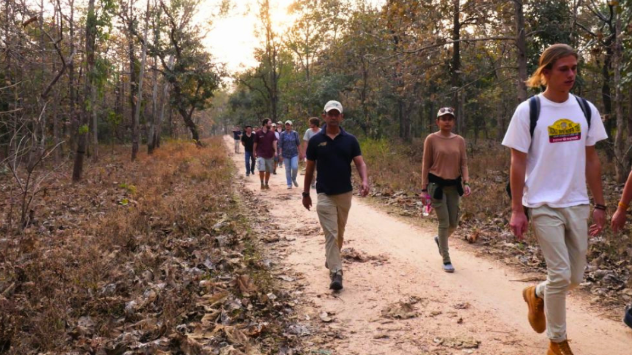 next gen members walk down a road during a learning journey