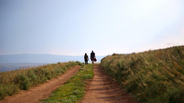 two adults walking on dirt path in Montana