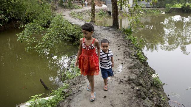 Children walking on dike in Bangladesh