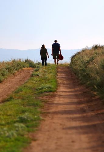 Two people walking along a road in Montana